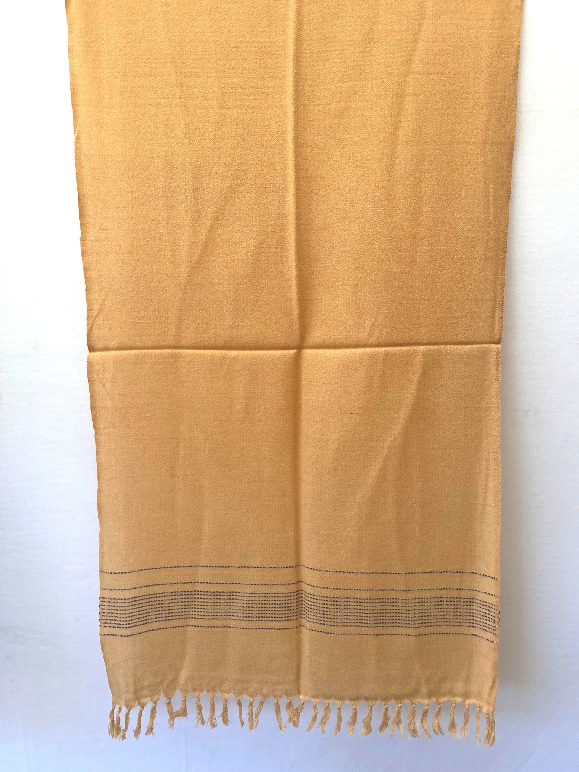 Handwoven merino wool stole in light lemon. And ends with a dotted navy blue border.