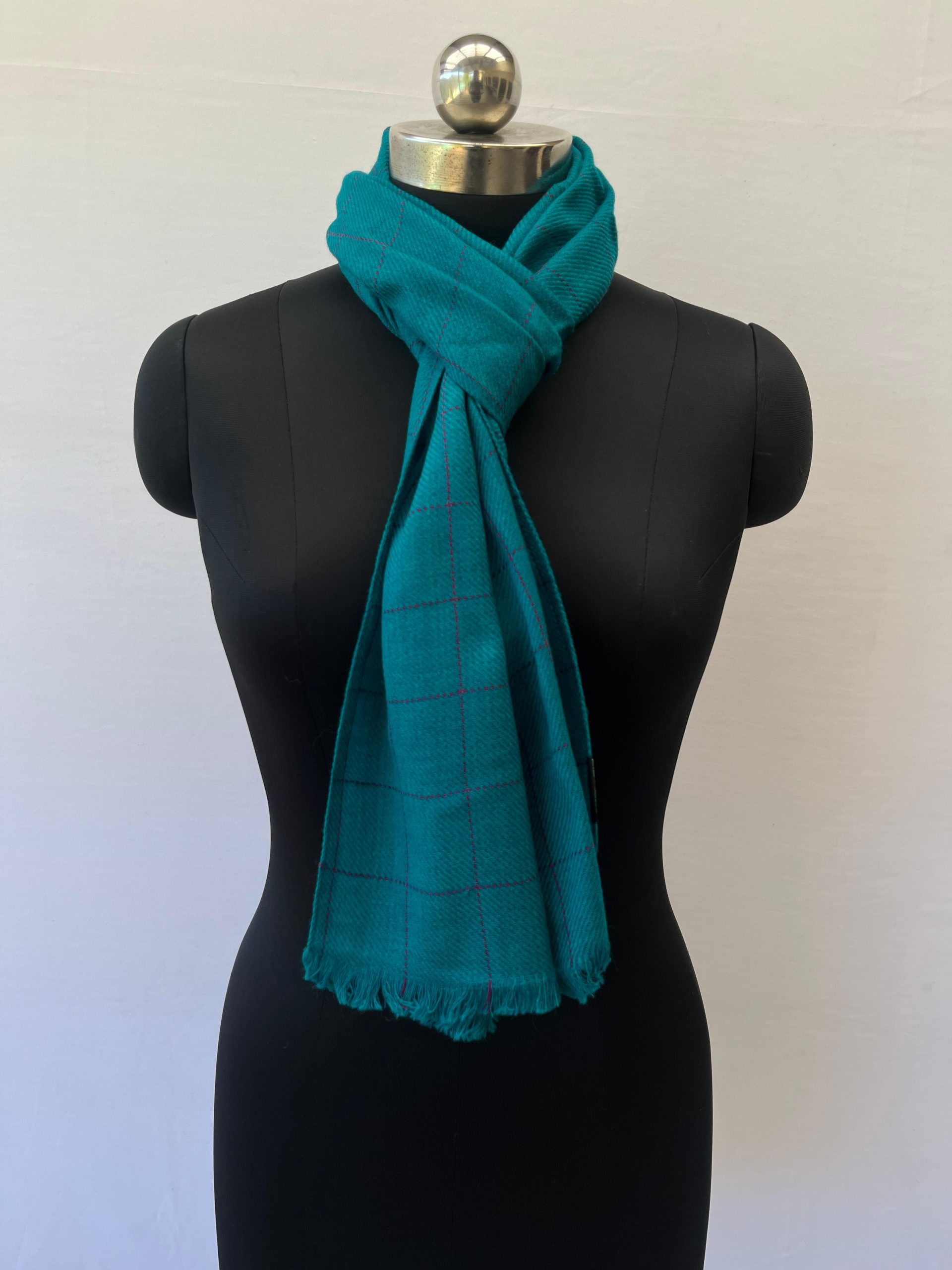 Handwoven merino wool scarf in teal with large navy checks woven into the design