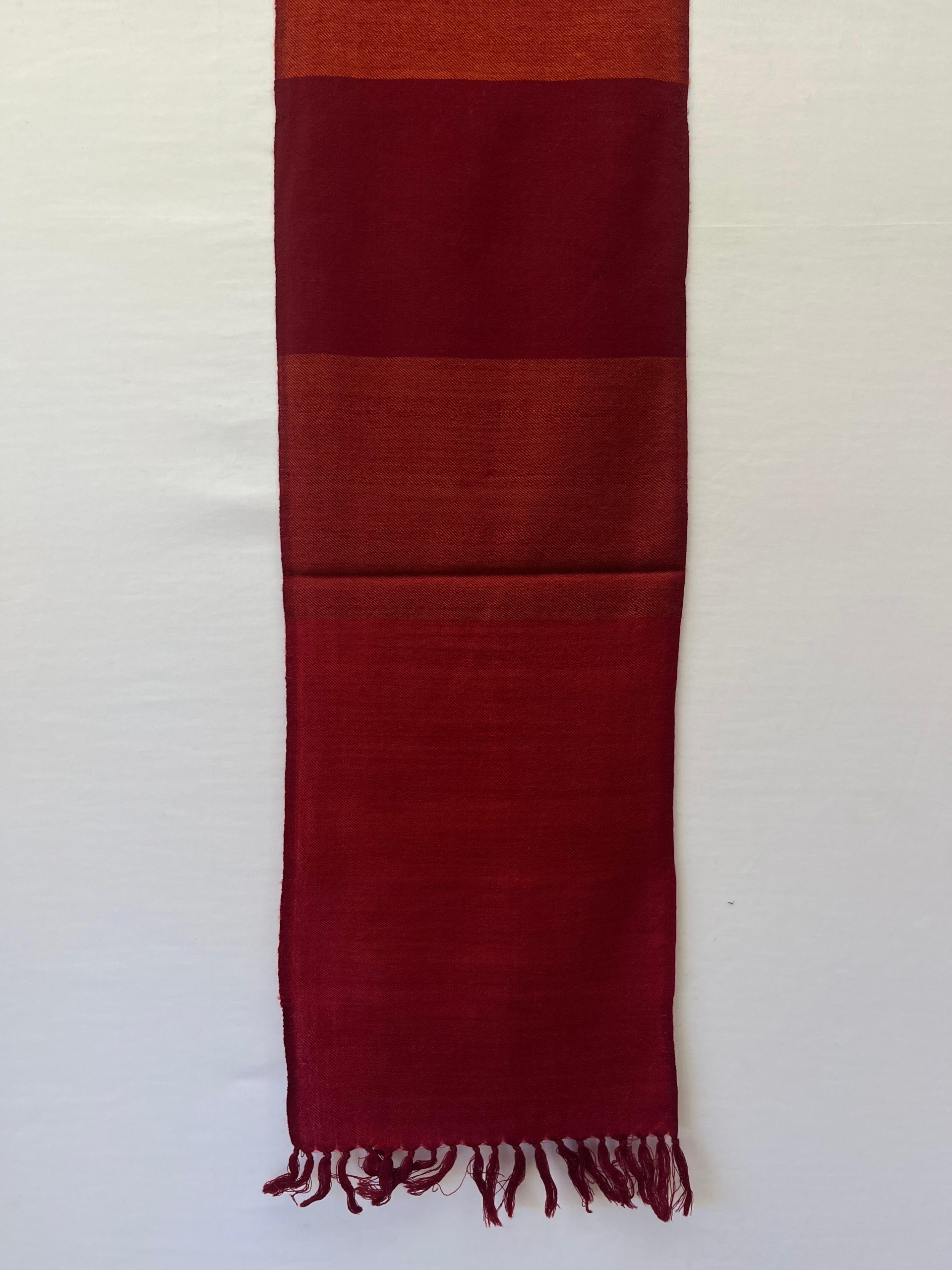 Merino wool handwoven scarf with broad stripes in cherry red, maroon and orange with a dark orange weft