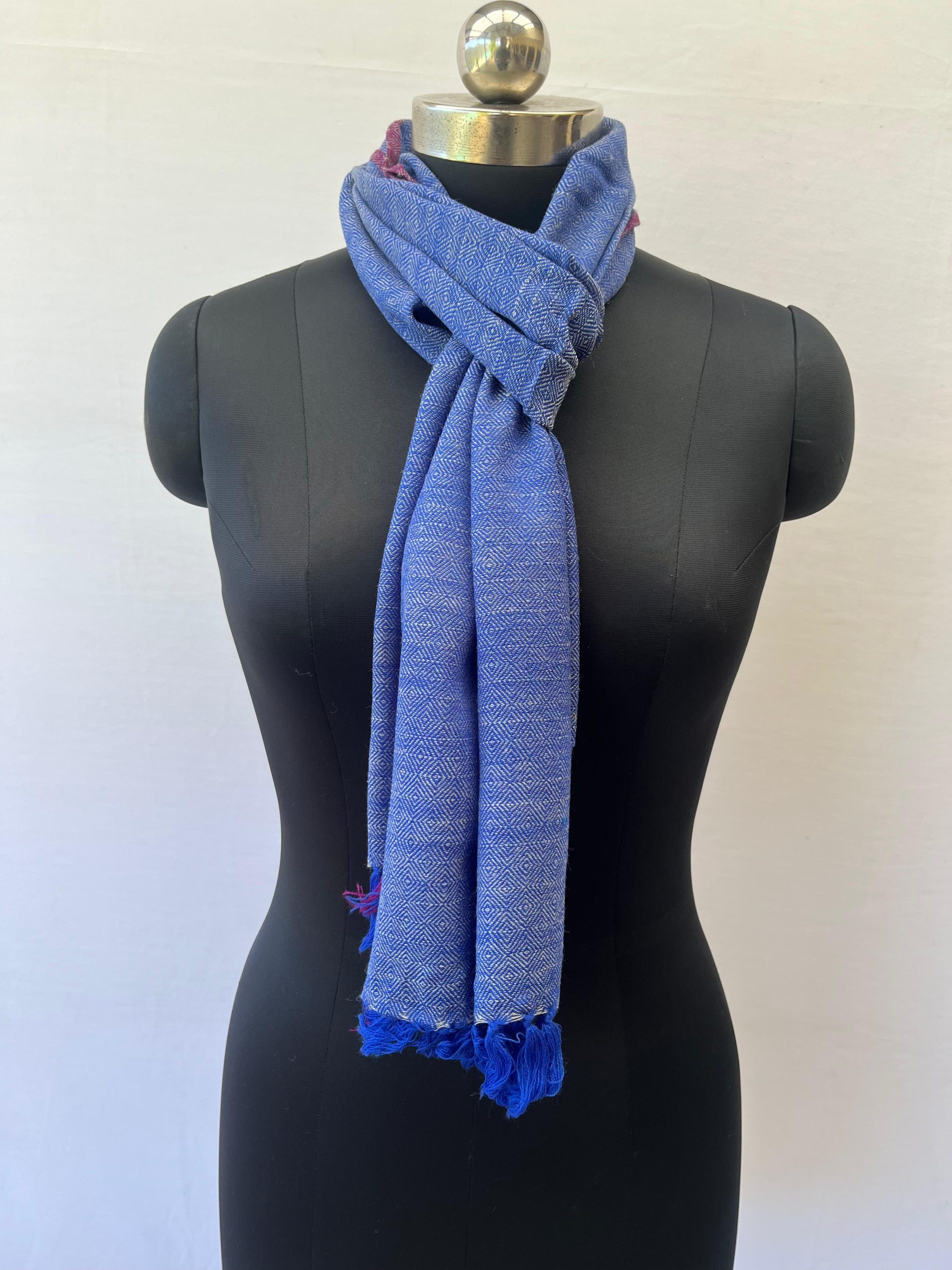 Handwoven merino wool scarf in royal blue diamond pattern with a white weft and thin red selvedge