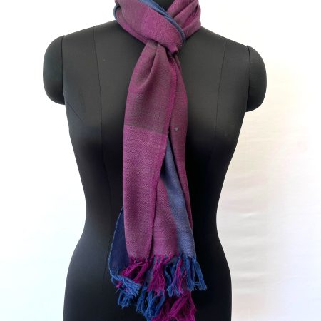 Handwoven merino wool scarf in large checks in teal, purple, wine and magenta. All with a hint of royal blue.