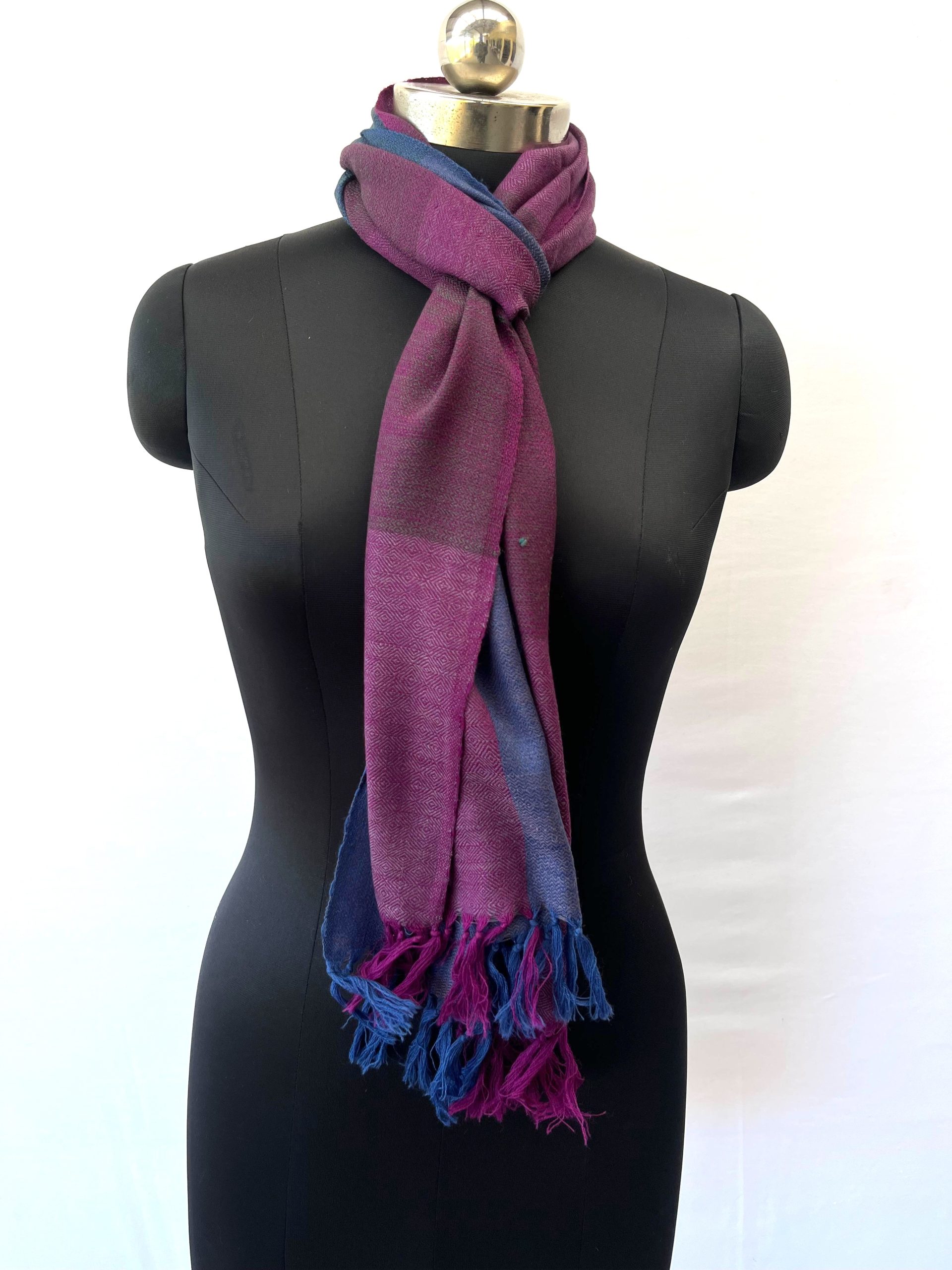 Handwoven merino wool scarf in large checks in teal, purple, wine and magenta. All with a hint of royal blue.