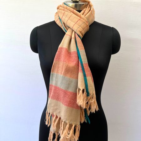 Handwoven merino wool stole in creamish yellow with thin maroon and seafood green vertical stripes. And ending with a border of seafood green and red stripes. All contained between thin cobalt blue selvedge on either side