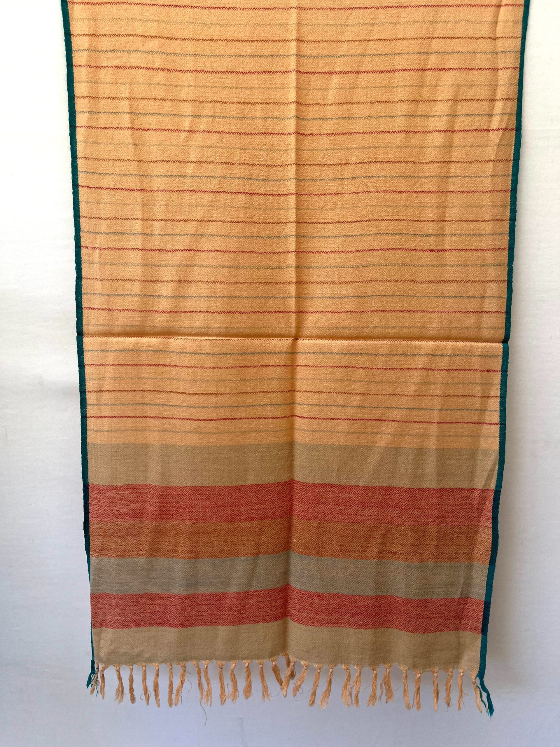 Handwoven merino wool stole in creamish yellow with thin maroon and seafood green vertical stripes. And ending with a border of seafood green and red stripes. All contained between thin cobalt blue selvedge on either side