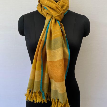 Handwoven merino wool stole in mustard yellow with thin stripes of red, yellow and seafoam green.