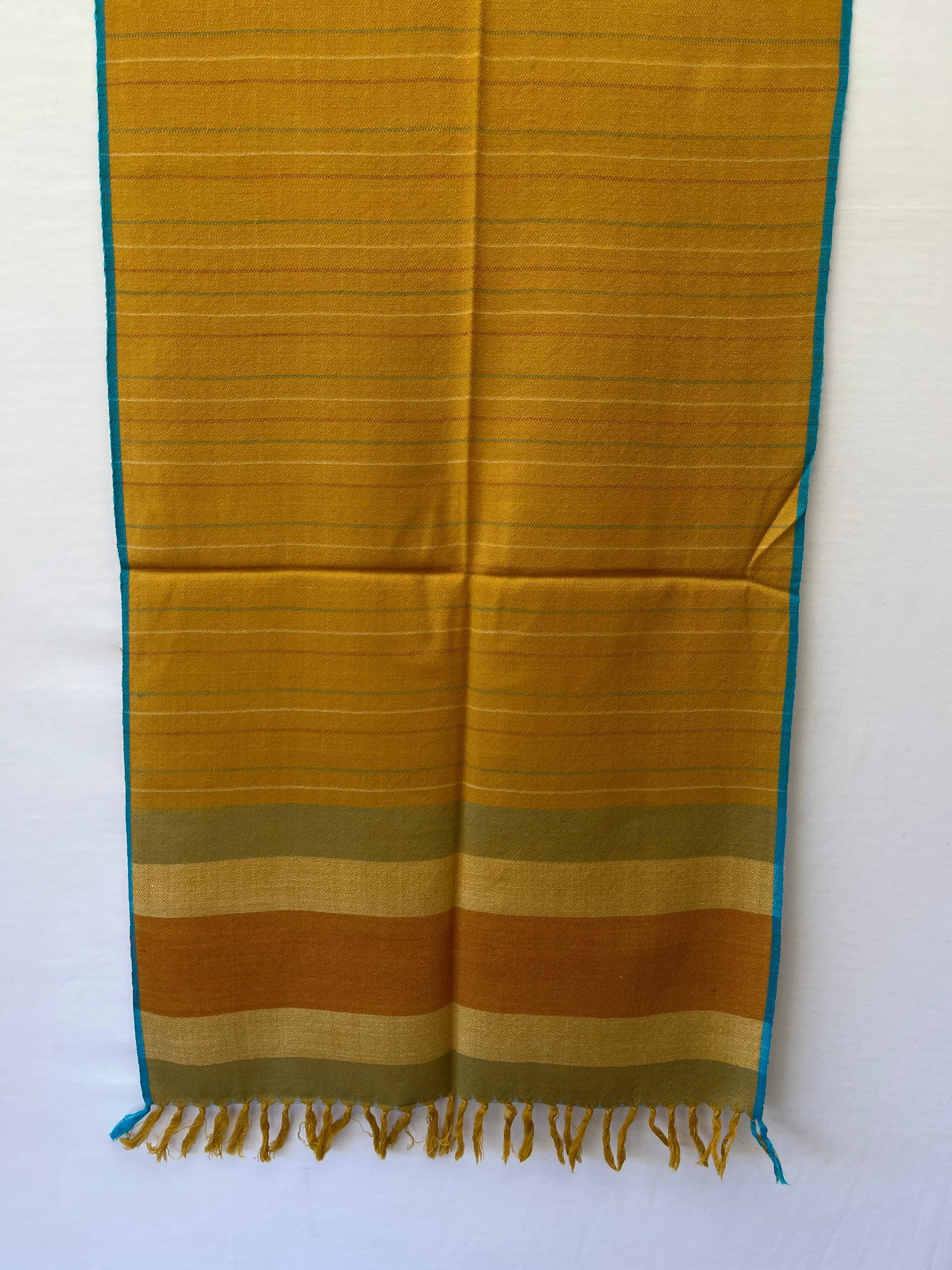 Handwoven merino wool stole in mustard yellow with thin stripes of red, yellow and seafoam green.