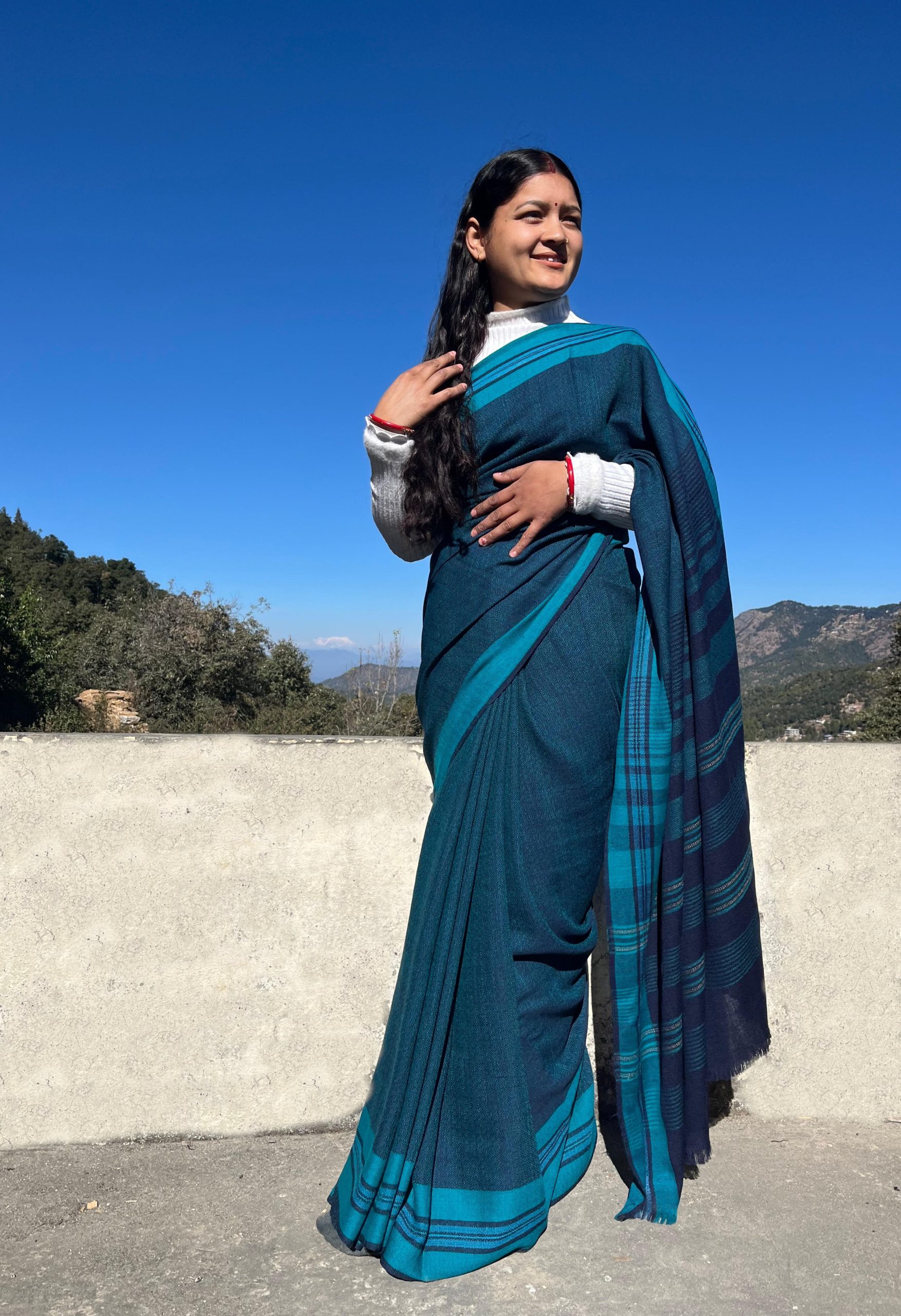 Handwoven azure blue merino wool saree, with a capri blue border