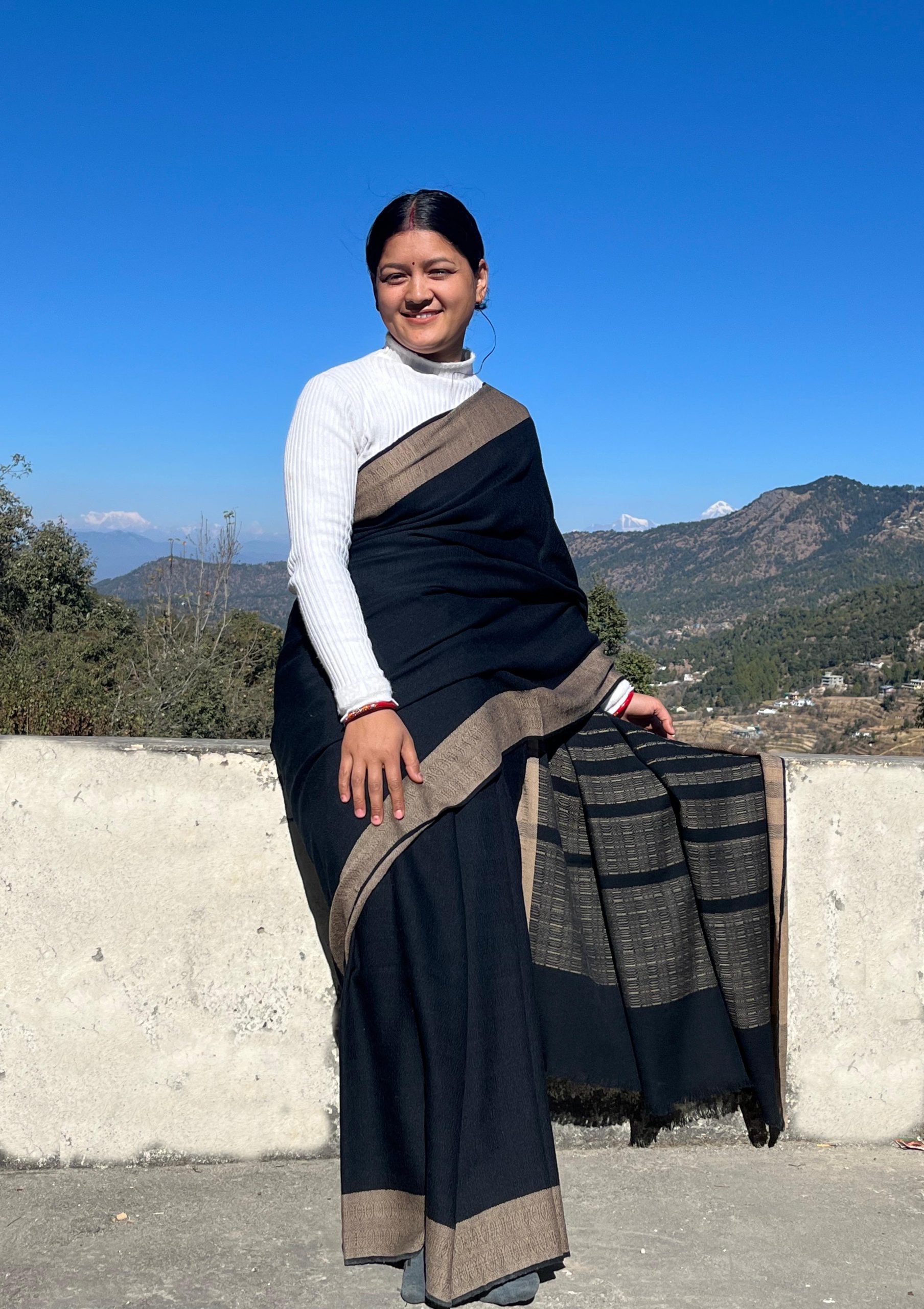 Handwoven merino wool saree in black with a caramel brown border.