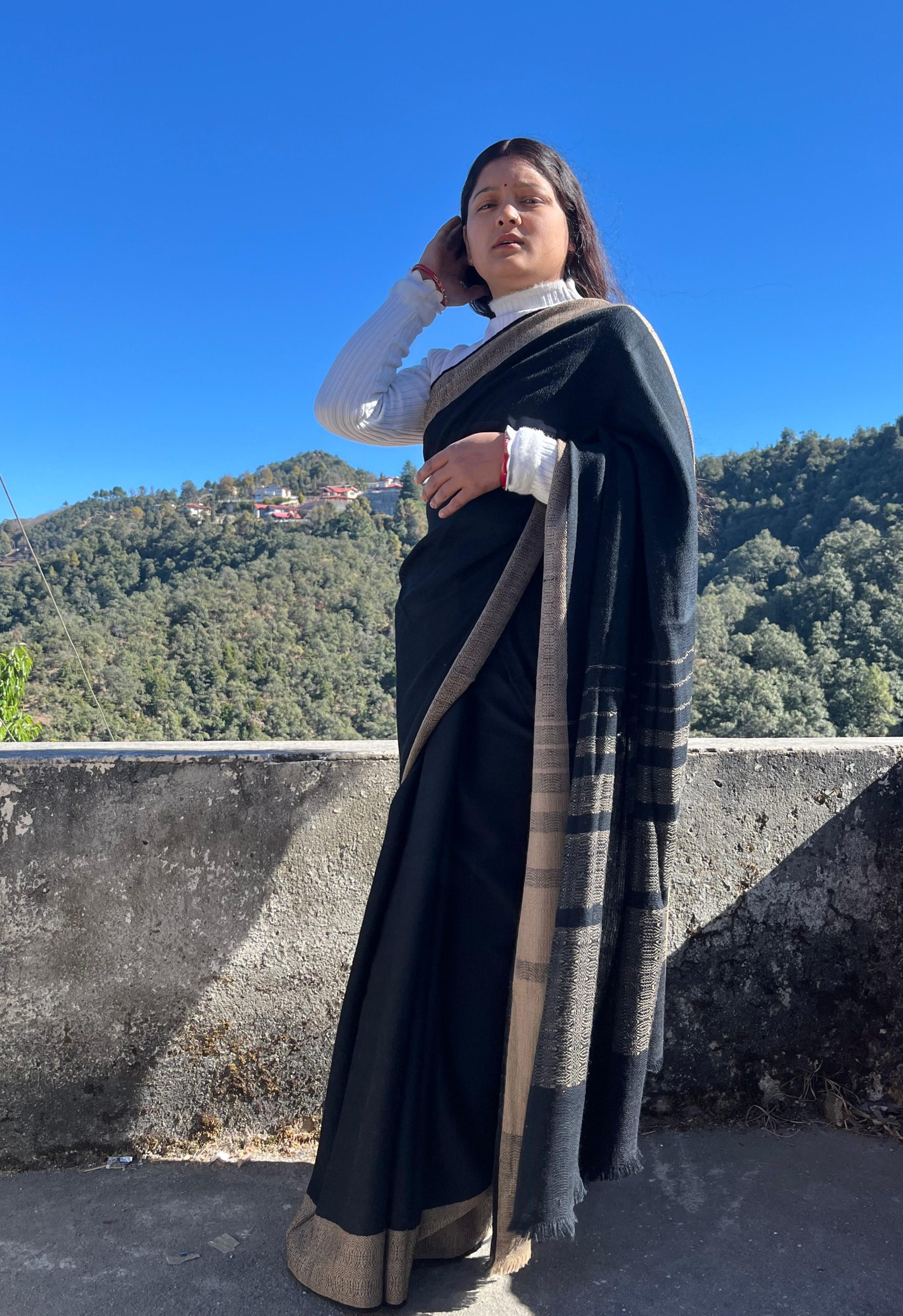 Handwoven merino wool saree in black with a caramel brown border.