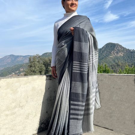 Woman wearing a handwoven merino wool saree in black and white. With the soft gradation making it look charcoal gray.