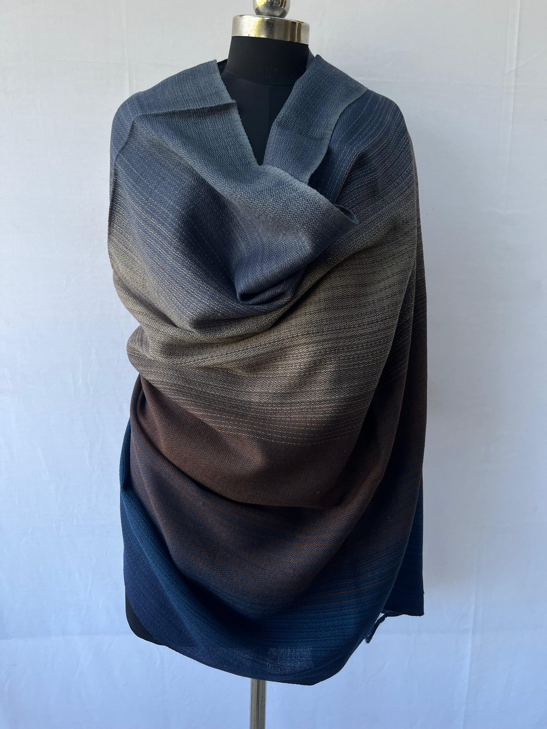 Handwoven merino wool shawl in horizontal gradation of steel blue, pewter, caramel and deep midnight blue