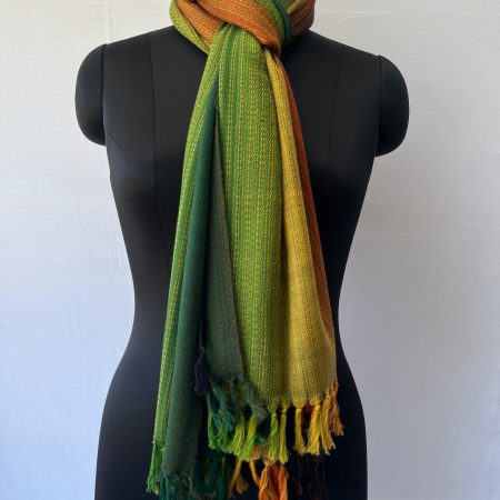 Merino wool handwoven stole in vertical gradation - from the left a deep forest green to a shamrock green to yellow, cerise and deep red.
