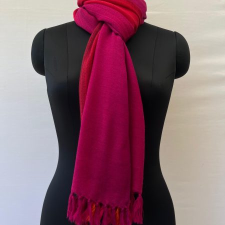 Handwoven merino wool stole in gradation with shades from bright deep magenta and ending in a deep red.