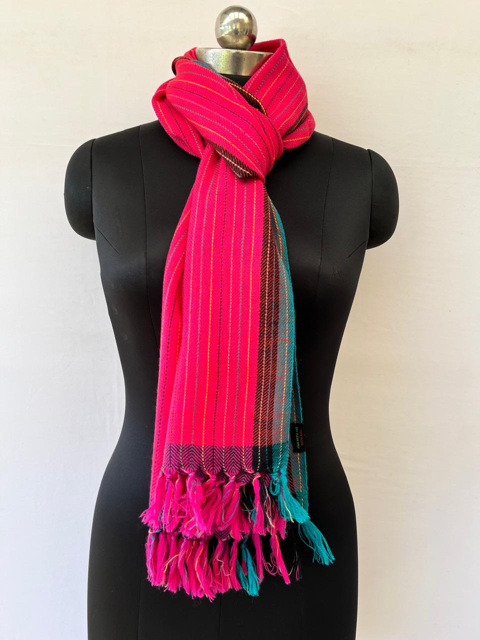 Hand-woven merino wool stole in hot pink with vertical stripes in black and yellow. With a teal and black selvedge