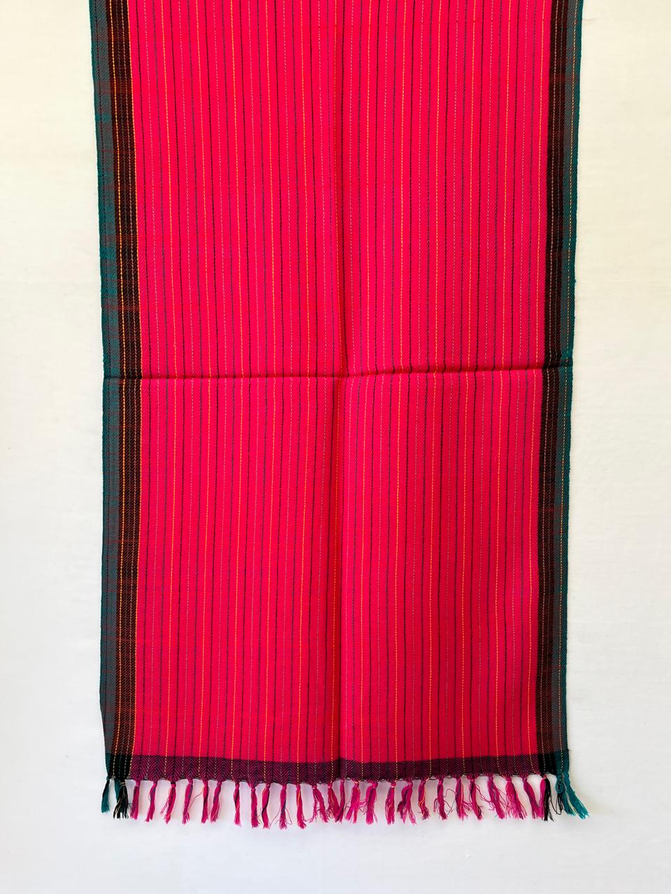Hand-woven merino wool stole in hot pink with vertical stripes in black and yellow. With a teal and black selvedge