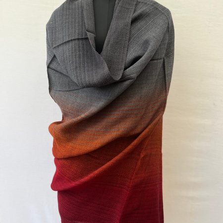 Hand-woven merino wool shawl in ombre weave with (from left to right) - warm gray, silver, orange and red