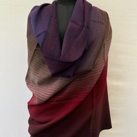 Hand-woven merino wool shawl in ombre weave with (from left to right) - plum, purple, walnut, silver, red and maroon.