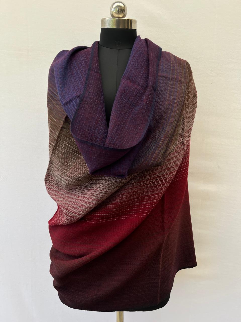 Hand-woven merino wool shawl in ombre weave with (from left to right) - plum, purple, walnut, silver, red and maroon.