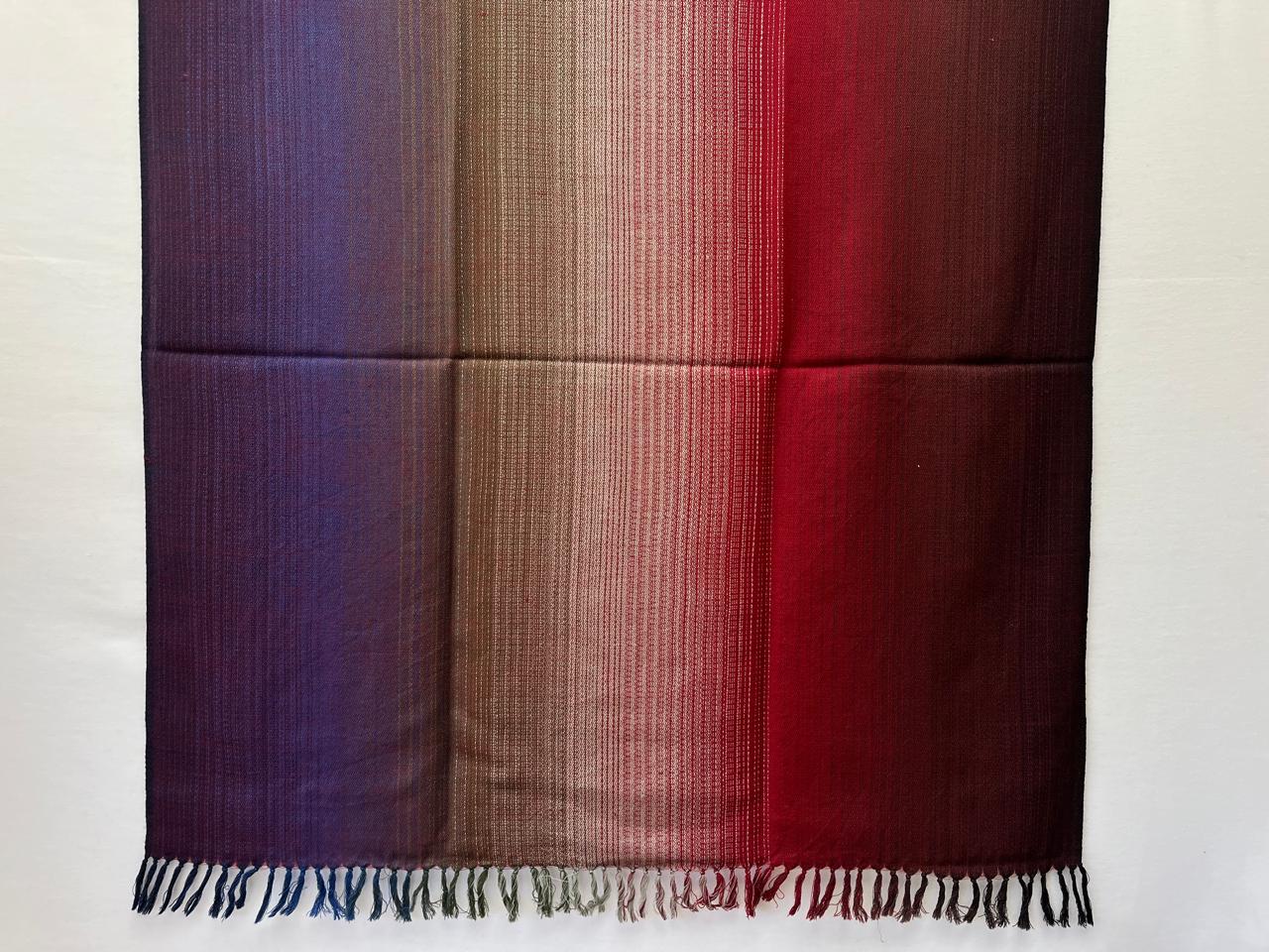 Hand-woven merino wool shawl in ombre weave with (from left to right) - plum, purple, walnut, silver, red and maroon.