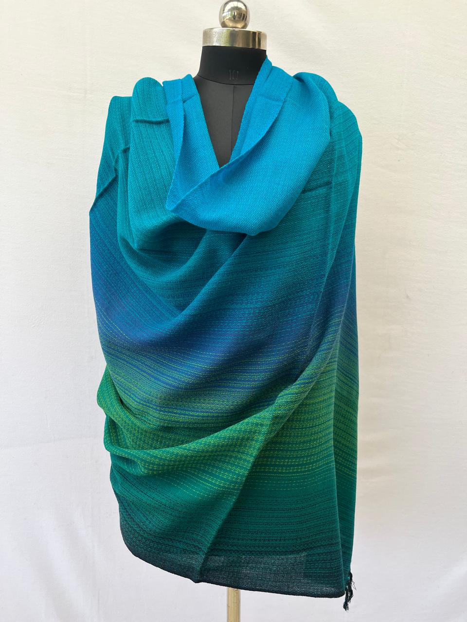 Hand-woven merino wool shawl in ombre weave with (from left to right) - bright blue, sky blue, cornflower blue. fern, shamrock and pine
