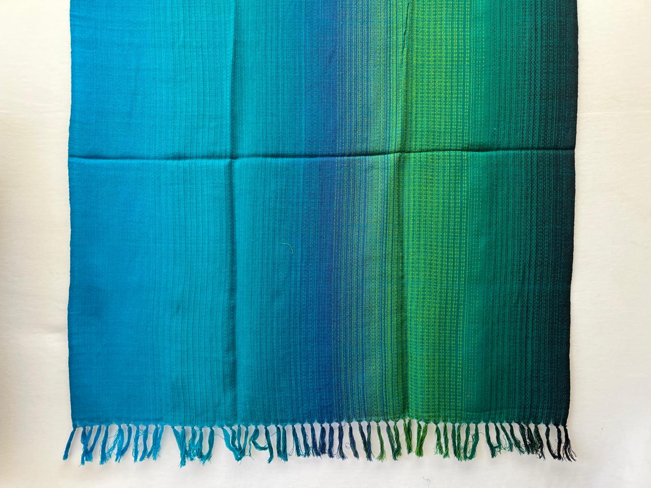 Hand-woven merino wool shawl in ombre weave with (from left to right) - bright blue, sky blue, cornflower blue. fern, shamrock and pine