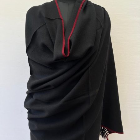 Deep blacl hand-woven merino wool shawl with a thin red selvedge