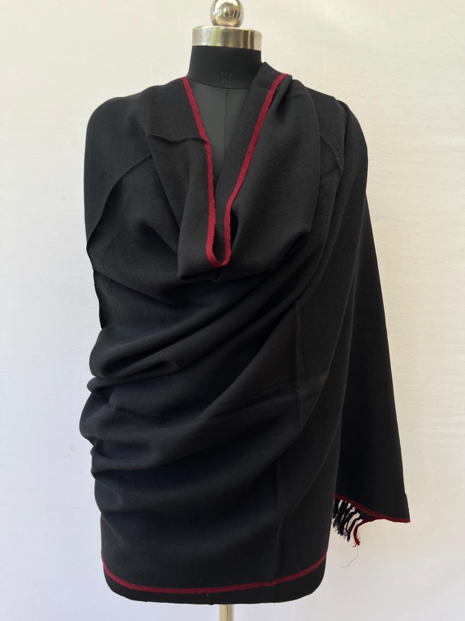 Deep blacl hand-woven merino wool shawl with a thin red selvedge