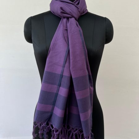 Hand woven cotton stole in aubergine with a deep navy striped border at the bottom. Knotted on a mannequin.
