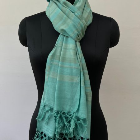 Hand woven cotton stole in tiffany blue with silver and arctic blue stripes. Knotted on a mannequin.