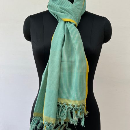 Graduated stripes in white on a pistachio background, handwoven on cotton. With a thin mustard stripe at each end. Knotted on a mannequin