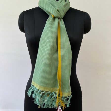 Graduated stripes in white on a seafoam green background, handwoven on cotton. With a thin mustard stripe at each end. Knotted on a mannequin.