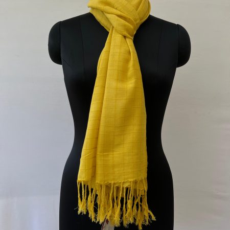 Hand woven cotton stole in honey yellow with brown checks. Knotted on a mannequin.