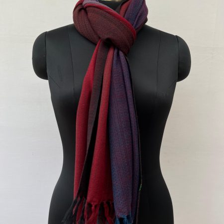 Ombre hand woven merino wool stole in deep purple, silver, wine red and ruby. Knotted on a mannequin.