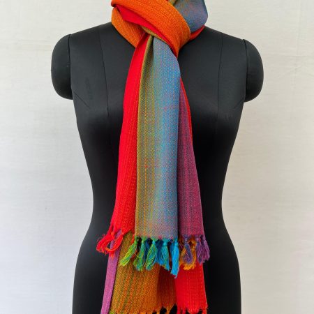 Ombre hand-woven merino wool stole that starts with amethyst, goes into purple, blue, green hint of yellow, orange and red. Knitted on a mannequin.