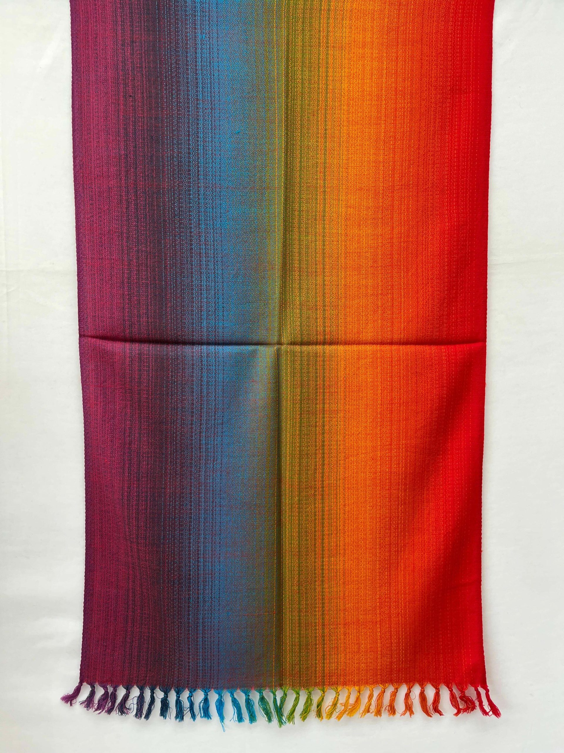 Ombre hand-woven merino wool stole that starts with amethyst, goes into purple, blue, green hint of yellow, orange and red.