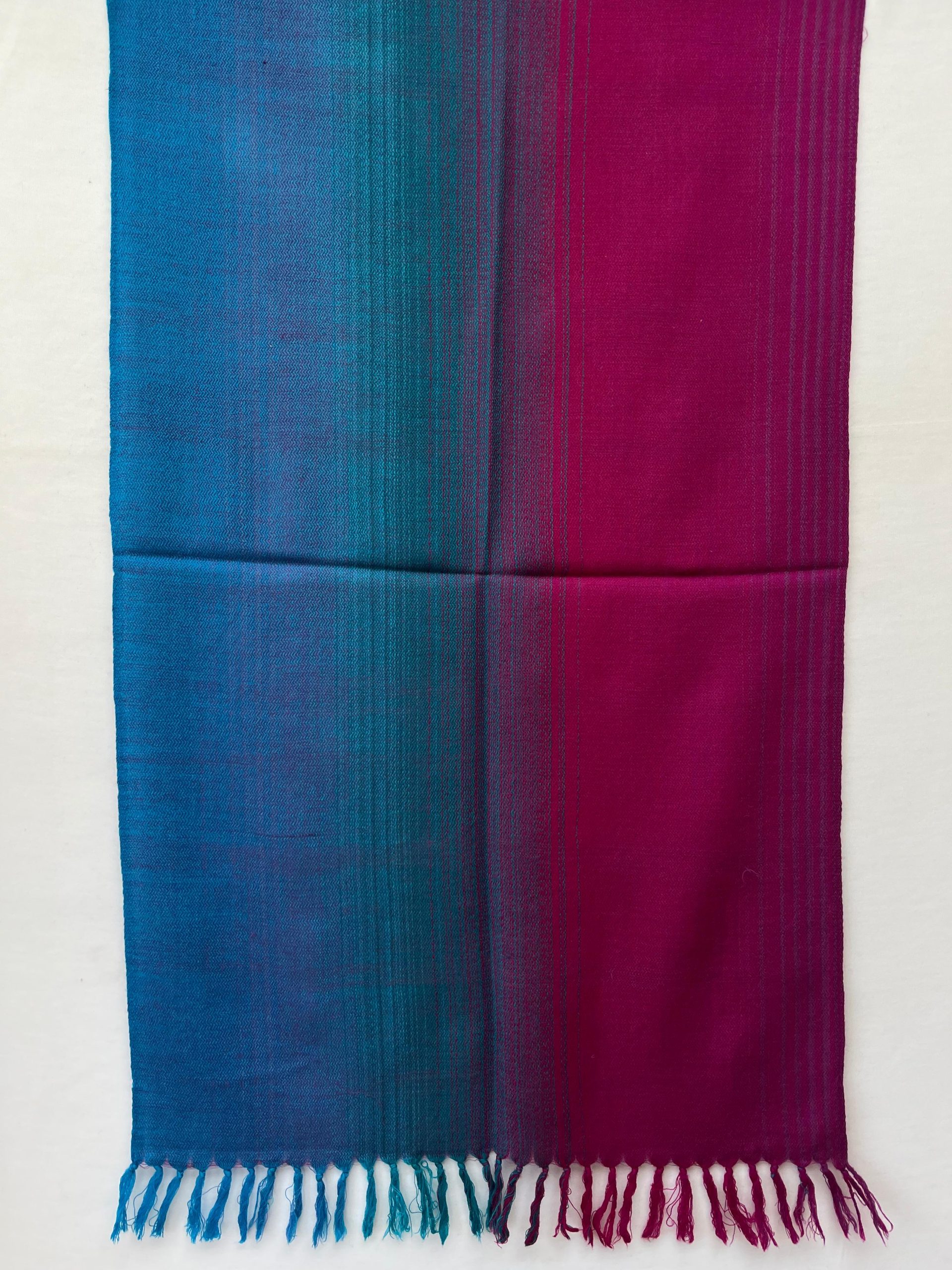 Ombre hand woven merino wool stole in a deep blue and deep aubergine.