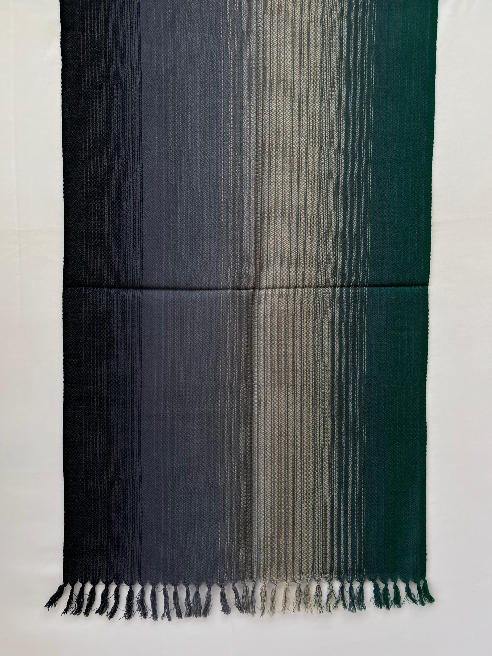 Ombre hand woven merino wool stole in shades of navy, mauve, charcoal, silver and deep teal.