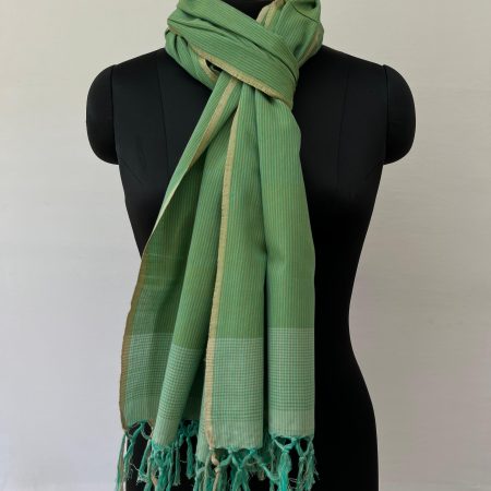Hand woven cotton stole in pistachio green with an overlay of sage green and thin vertical pin stripes for design, Knotted on a mannequin.