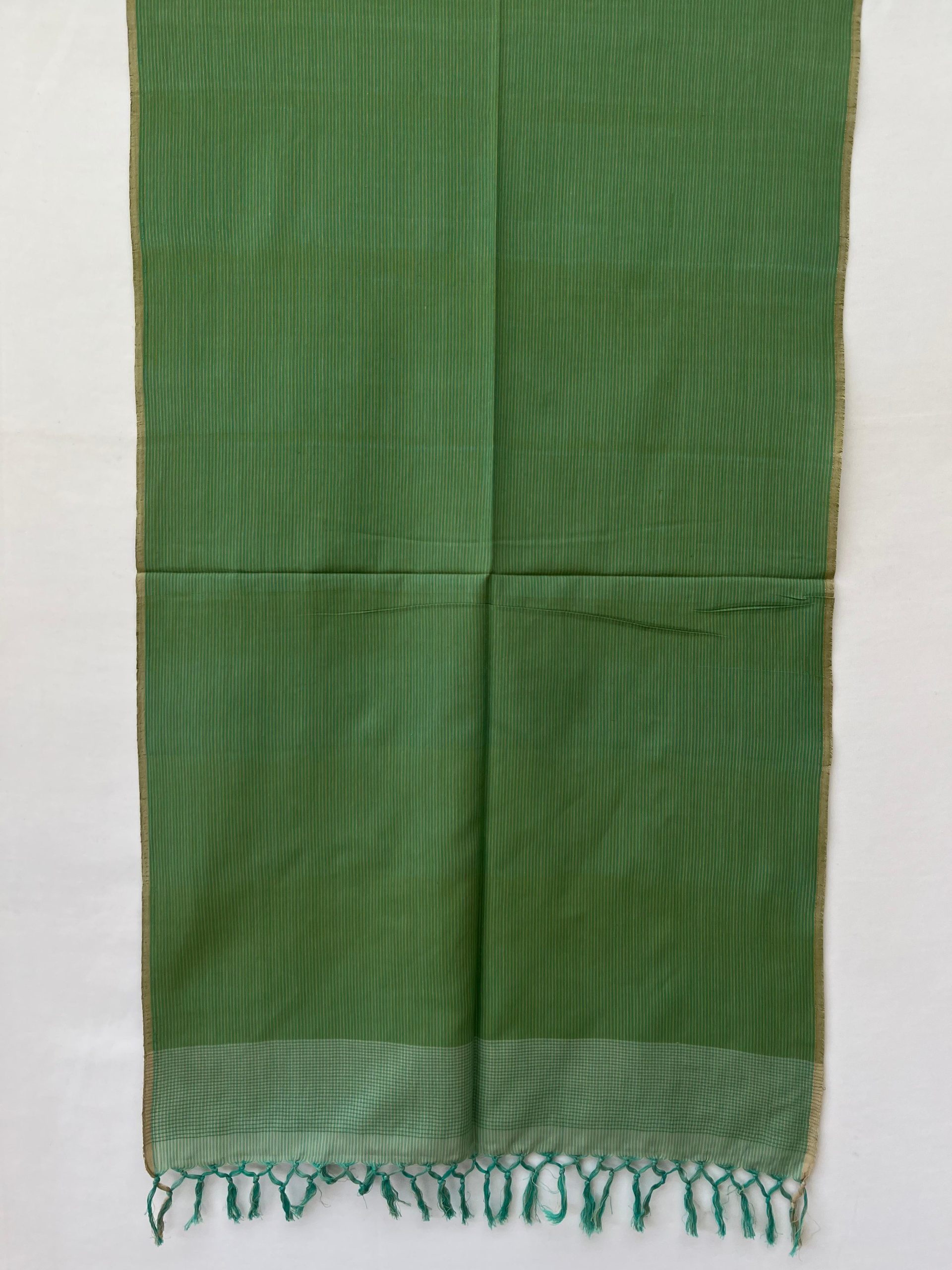 Hand woven cotton stole in pistachio green with an overlay of sage green and thin vertical pin stripes for design,