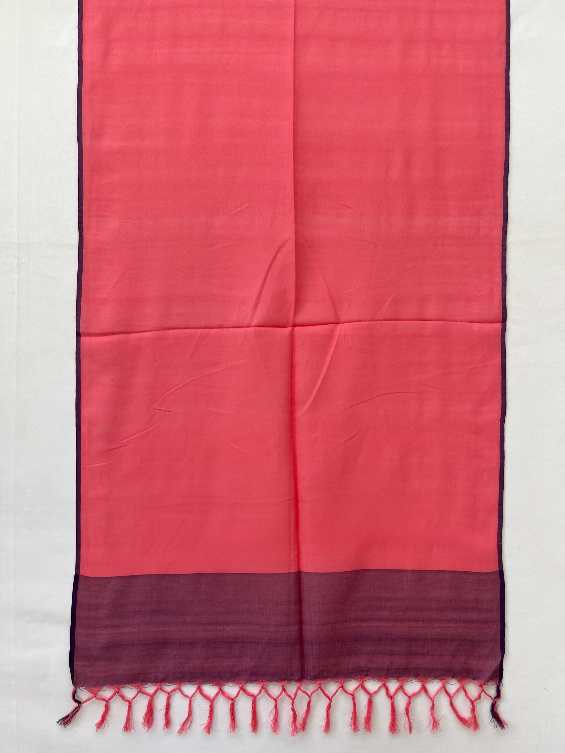 Hand-woven cotton stole in a deep pink, with a thin navy blue edging on both sides and a navy blue border.
