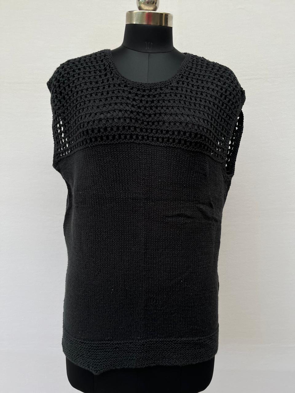 Mannequin is wearing a hand-knit cotton jaali top in black