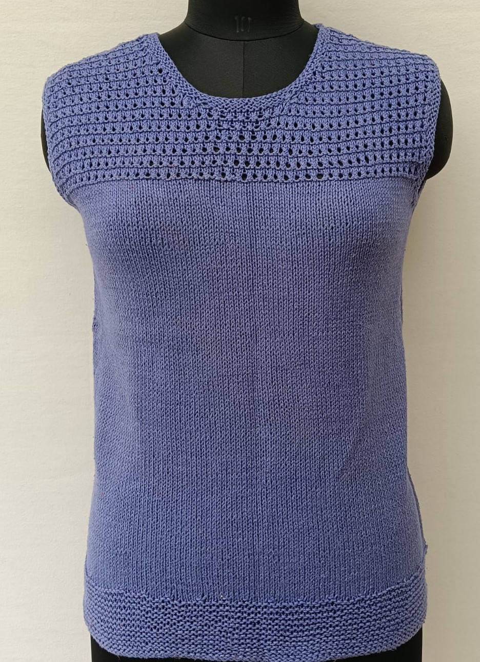 Mannequin is wearing a hand-knit cotton jaali top in heather