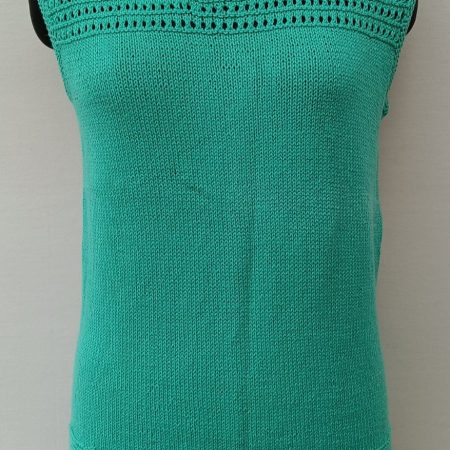 Mannequin is wearing a hand-knit cotton jaali top in mint green.