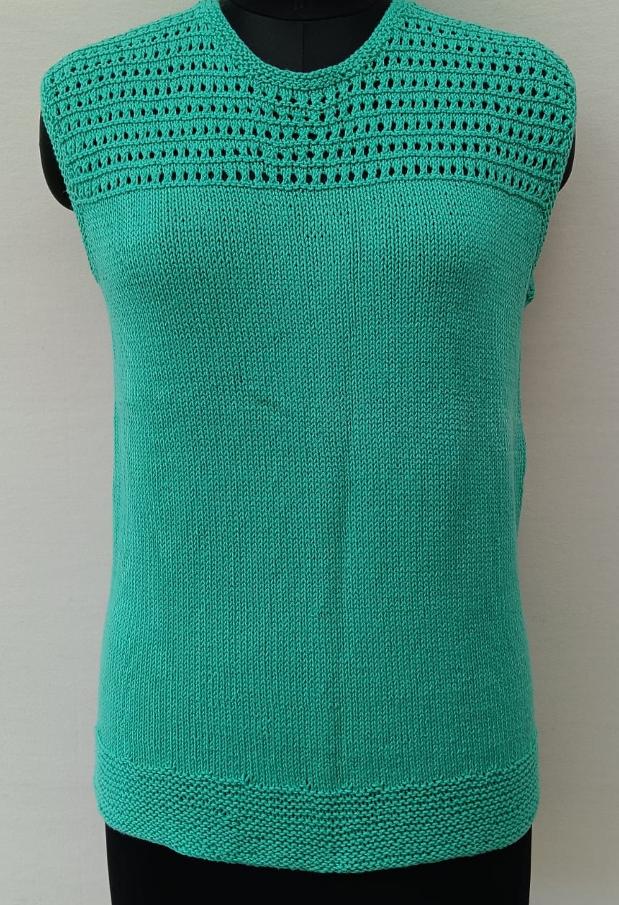 Mannequin is wearing a hand-knit cotton jaali top in mint green.