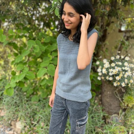 Model is wearing a hand-knit cotton jaali top in misty gray