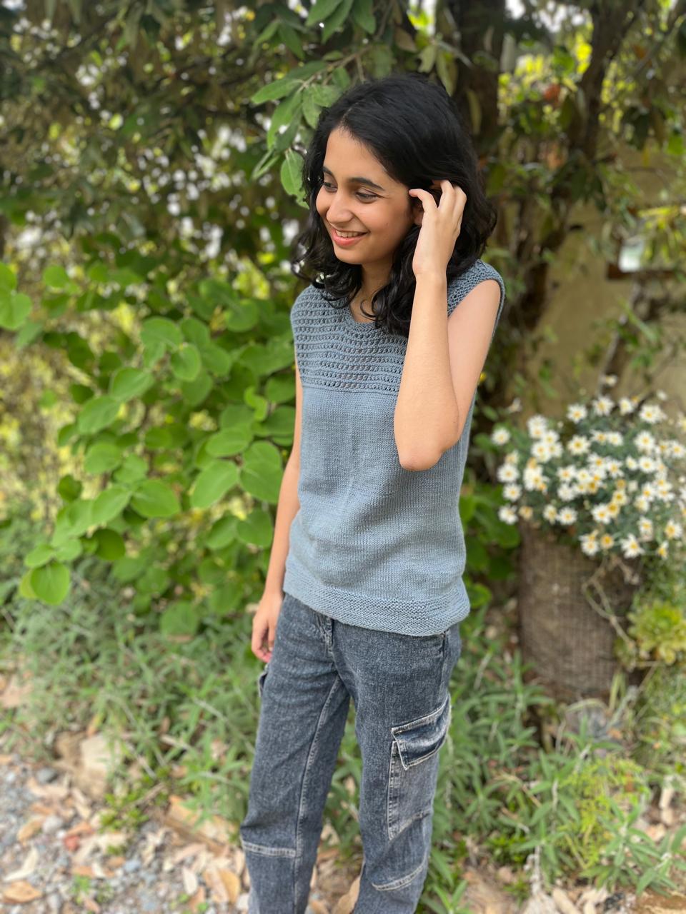 Model is wearing a hand-knit cotton jaali top in misty gray