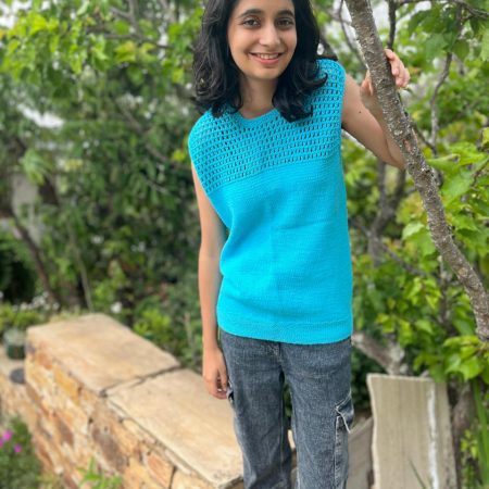 Model is wearing a hand-knit cotton jaali top in sky blue