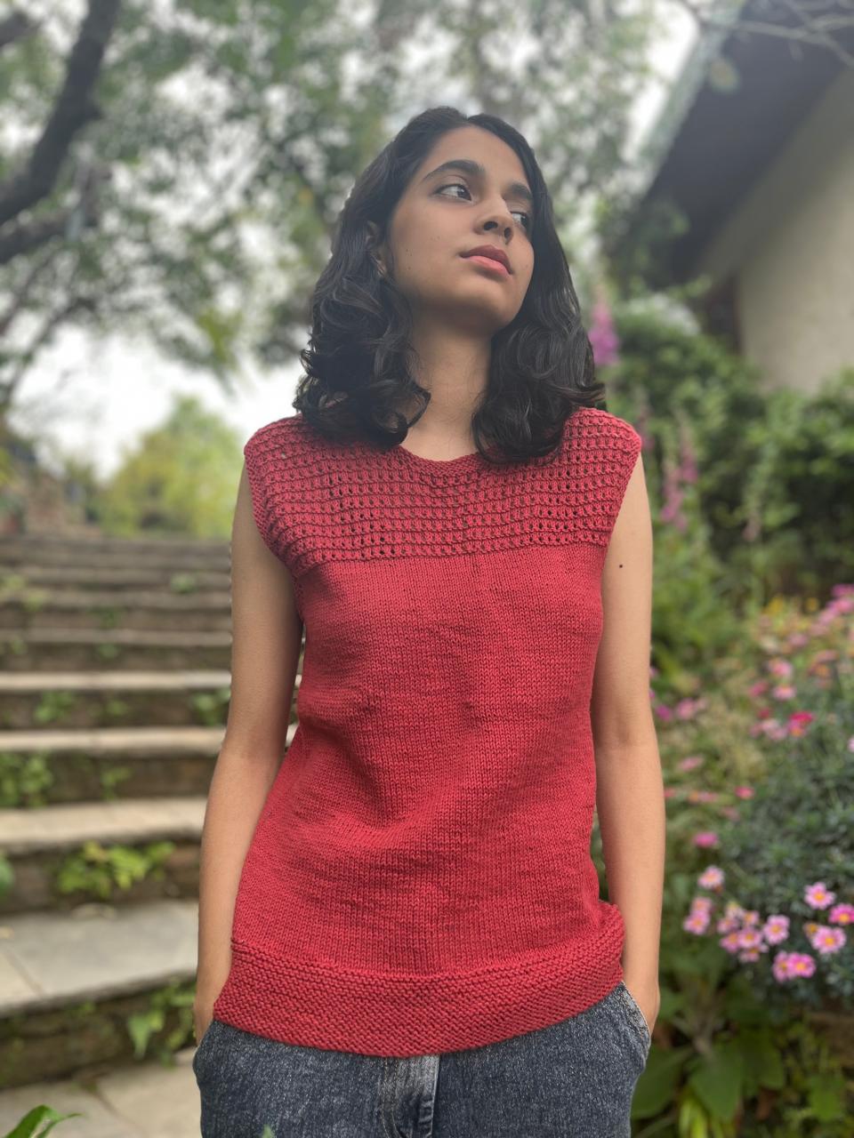 Model wearing a hand-knit cotton jaali top in crimson