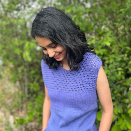 Model is wearing a hand-knit cotton jaali top in heather