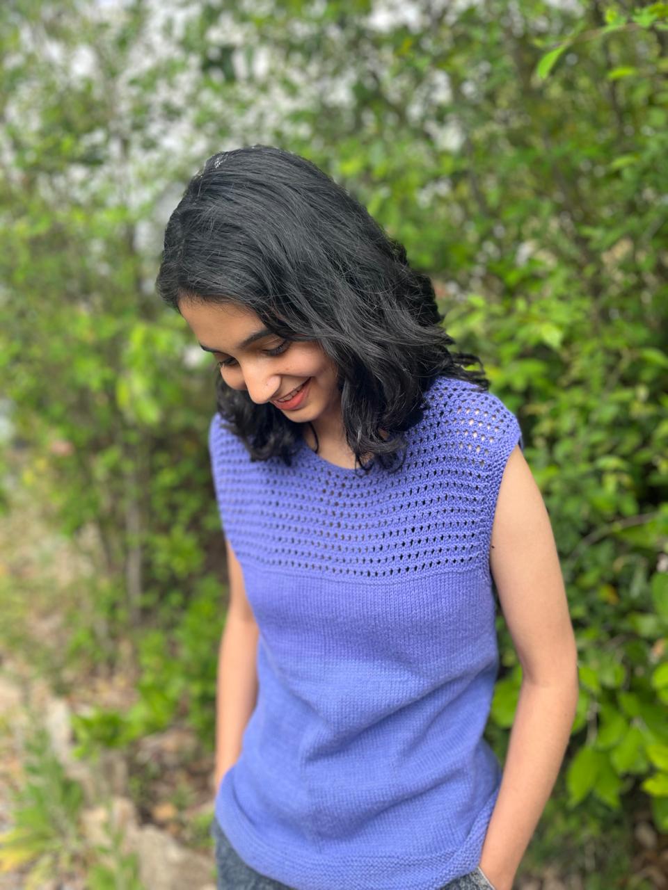 Model is wearing a hand-knit cotton jaali top in heather